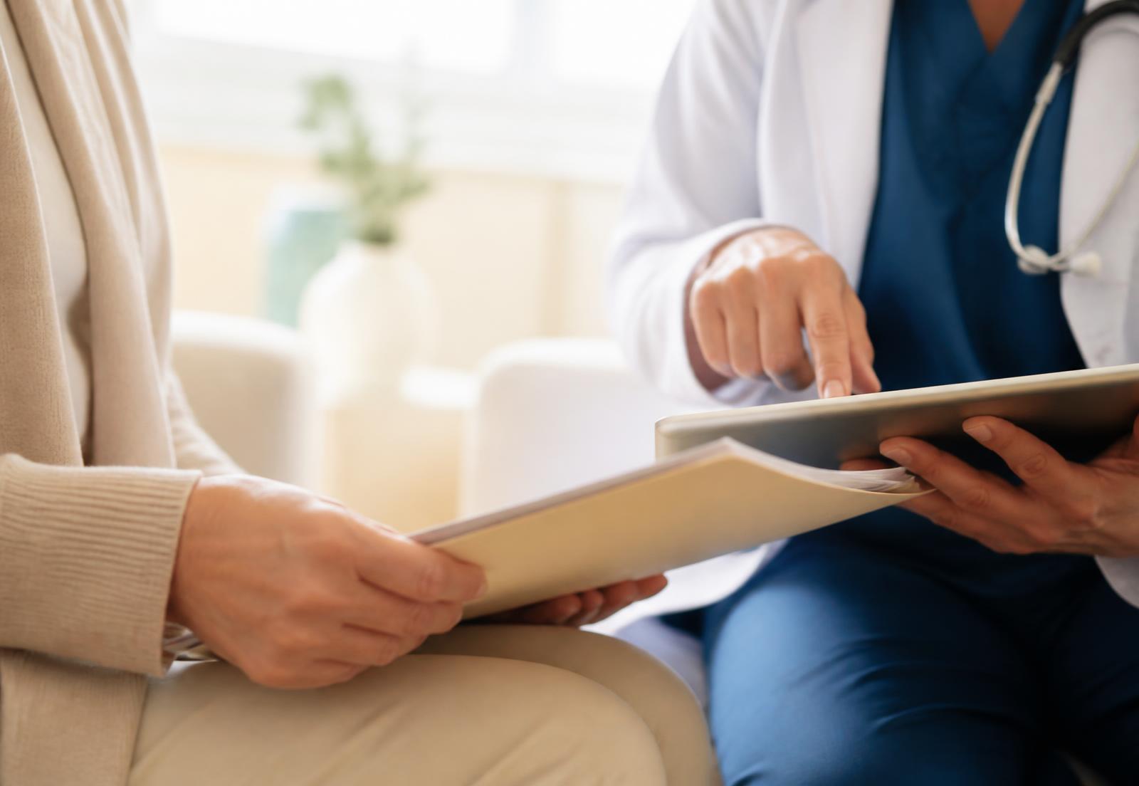 A physician reviewing a patient's medical file on a tablet